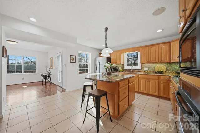 a kitchen with a sink a counter top space appliances and cabinets