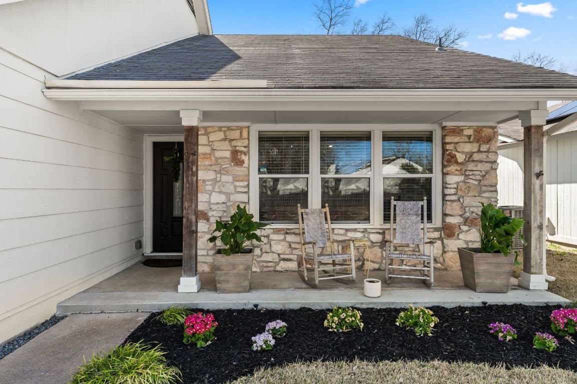 9715 Meadowheath Drive Austin, TX 78729 - Photo 1 of 27 a front view of a house with outdoor seating