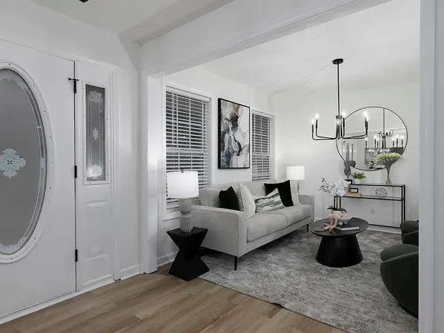 a living room with furniture chandelier and window