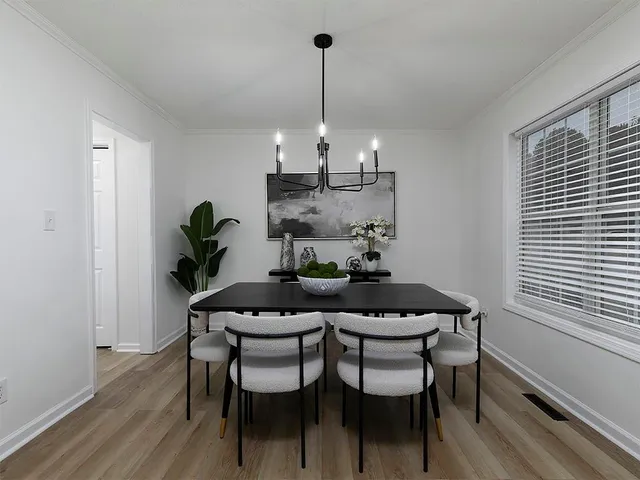 a view of a dining room with furniture wooden floor and chandelier