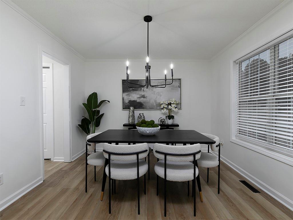 62 Smoak Field Road Griffin, GA 30223 - Photo 14 of 50 a dining room with furniture a chandelier and wooden floor