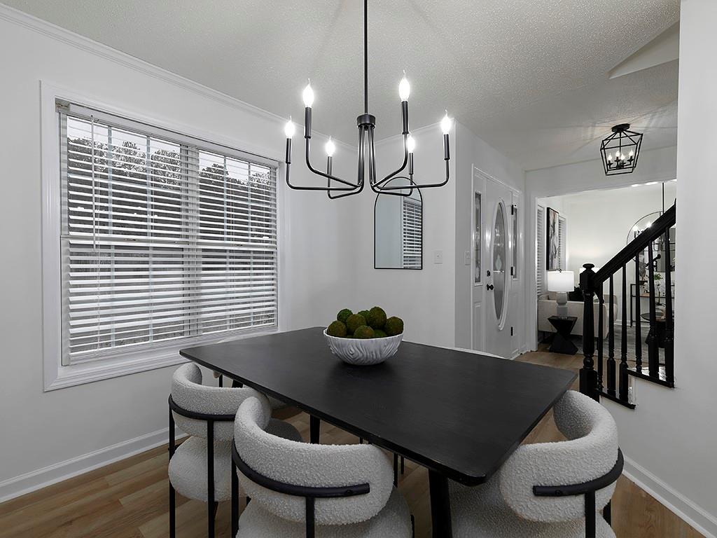 62 Smoak Field Road Griffin, GA 30223 - Photo 15 of 50 a view of a dining room with furniture wooden floor and chandelier