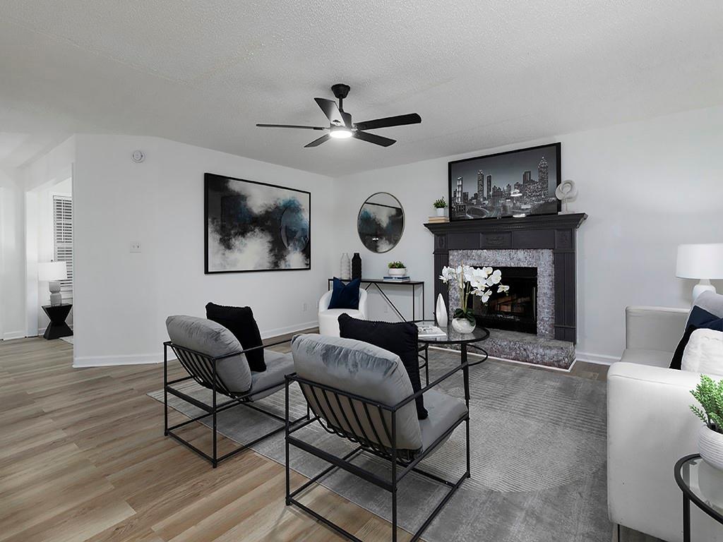 62 Smoak Field Road Griffin, GA 30223 - Photo 17 of 50 a living room with furniture a fireplace and a flat screen tv