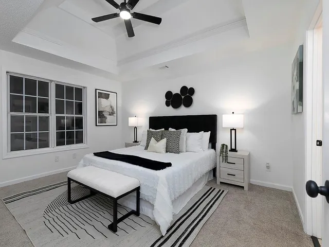 a bedroom with a bed and a chandelier