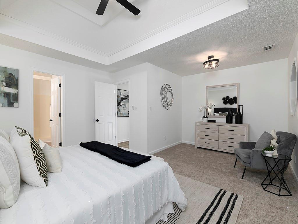 62 Smoak Field Road Griffin, GA 30223 - Photo 30 of 50 a bedroom with a bed and a chandelier