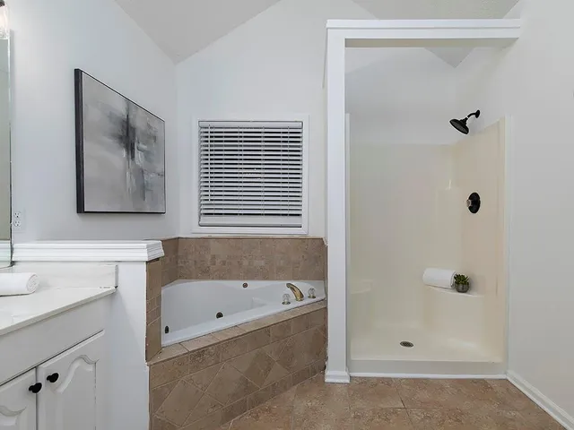 an empty room with a window and a ceiling fan