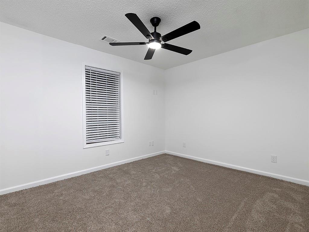 62 Smoak Field Road Griffin, GA 30223 - Photo 34 of 50 an empty room with a window and a ceiling fan