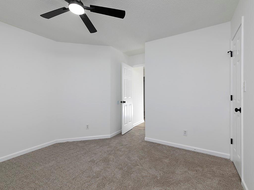 62 Smoak Field Road Griffin, GA 30223 - Photo 37 of 50 an empty room with a window and a ceiling fan
