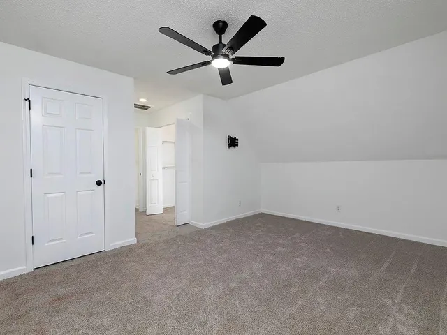 a view of a city street lined with buildings and trees