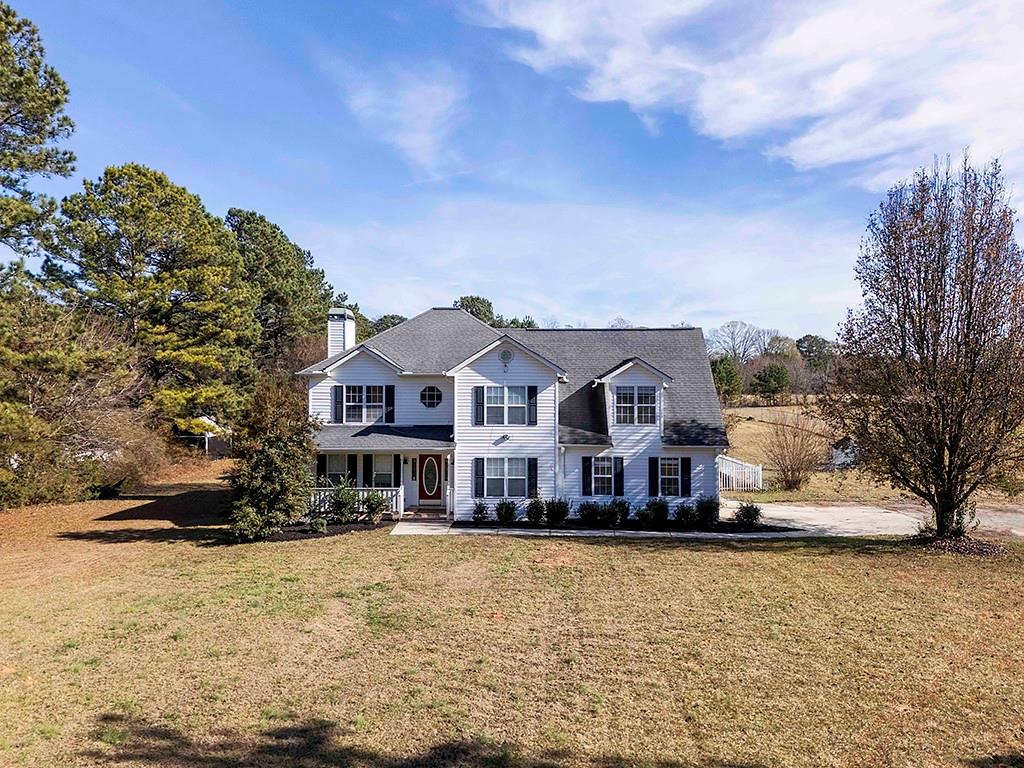 62 Smoak Field Road Griffin, GA 30223 - Photo 48 of 50 a front view of a house with a yard covered with snow and trees