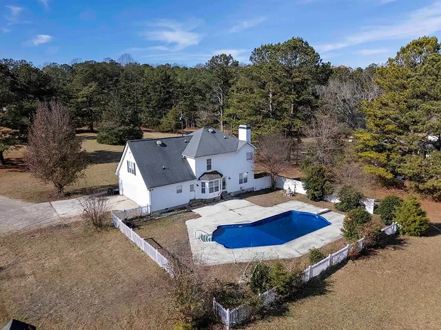 an aerial view of a house with a yard