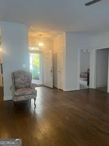 a living room with couches and a coffee table with wooden floor