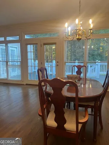 a view of a dining room with furniture wooden floor and chandelier