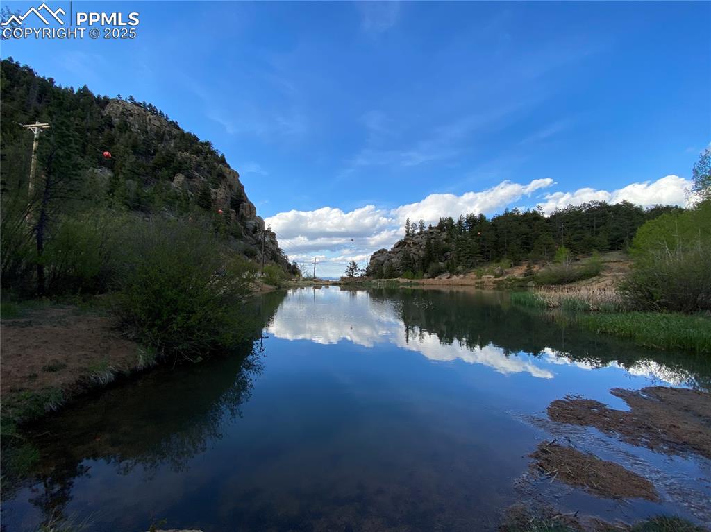 116 Happy Valley Road Manitou Springs, CO 80829 - Photo 23 of 25 a view of a lake in middle of forest