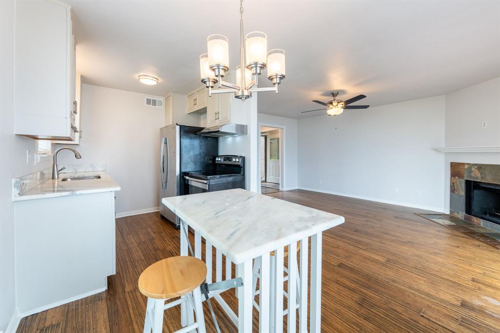 4610 Chaha Road, Unit 106 Garland, TX 75043 - Photo 13 of 25 a view of a dining room with furniture and wooden floor