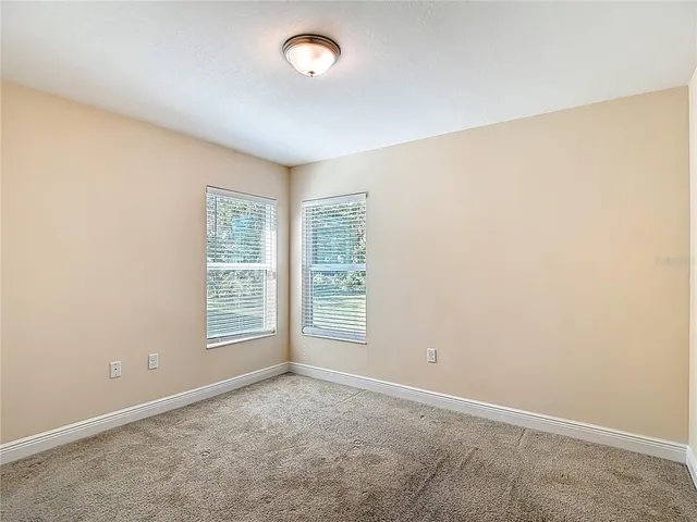 an empty room with a chandelier fan
