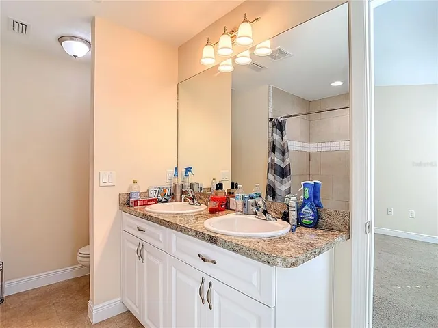 an aerial view of residential houses with outdoor space and swimming pool