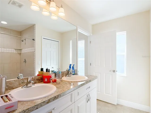 an aerial view of a house with swimming pool and large trees