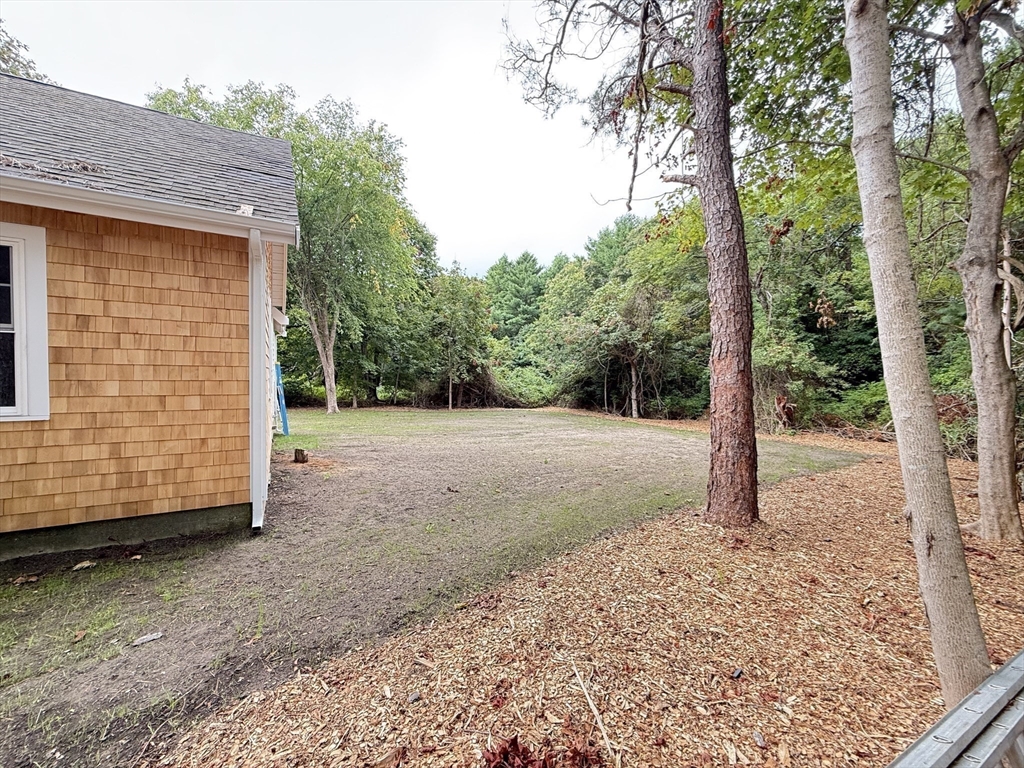 1469 Santuit-Newtown Road Barnstable, MA 02635 - Photo 5 of 18 a view of a backyard with large tree