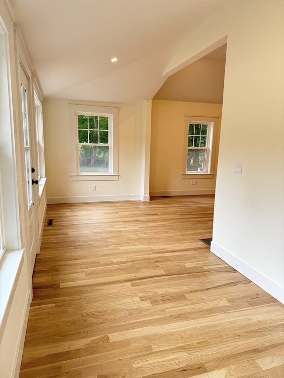 1469 Santuit-Newtown Road Barnstable, MA 02635 - Photo 6 of 18 a view of an empty room with a window and wooden floor