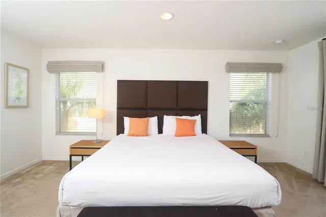 a bedroom with a large bed and a window