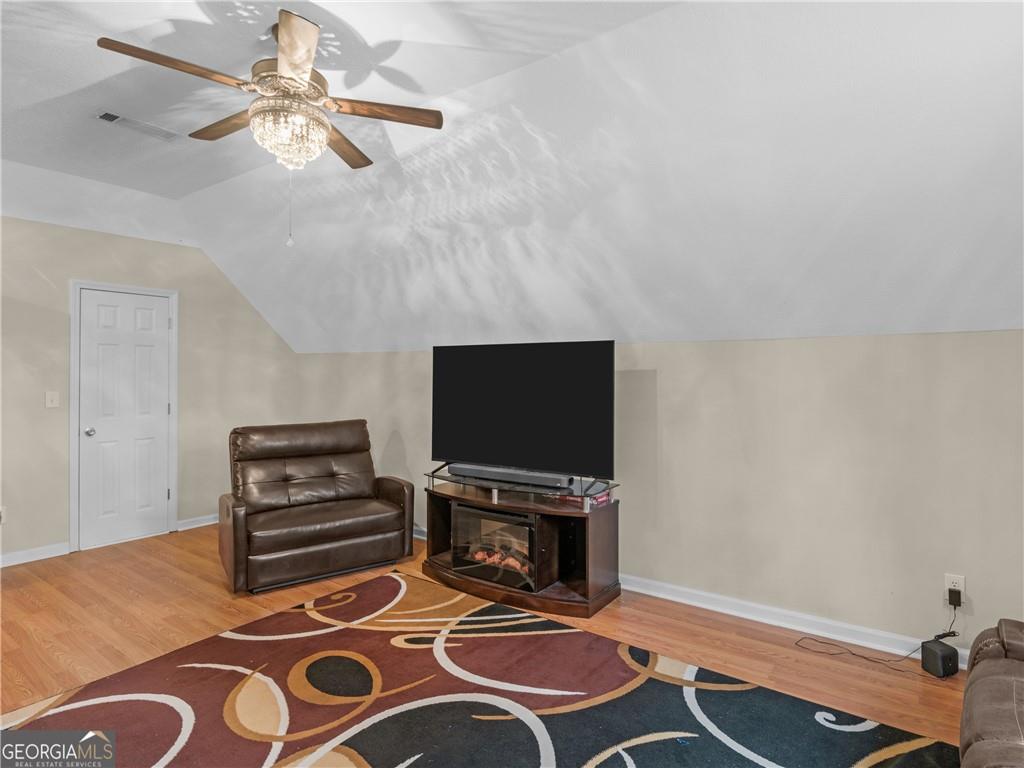 355 Parker Road Covington, GA 30014 - Photo 39 of 60 a living room with furniture and a flat screen tv