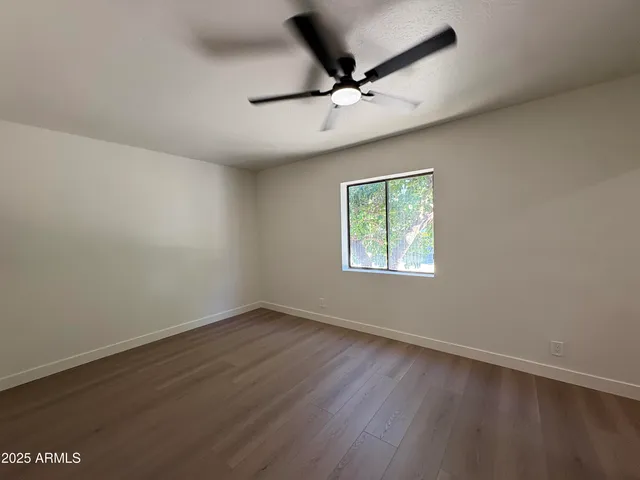 a bathroom with a granite countertop toilet sink and mirror