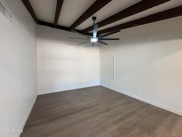 an empty room with wooden floor
