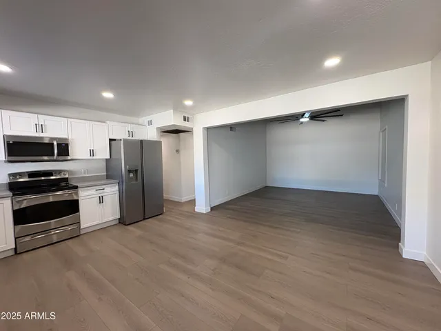 a view of a kitchen with a sink and a stove top oven