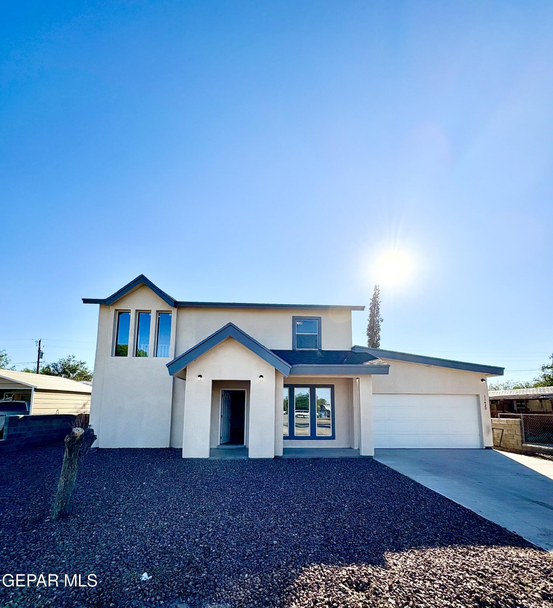 11420 Doris Road Socorro, TX 79927 - Photo 5 of 27 a front view of a house with a yard and garage
