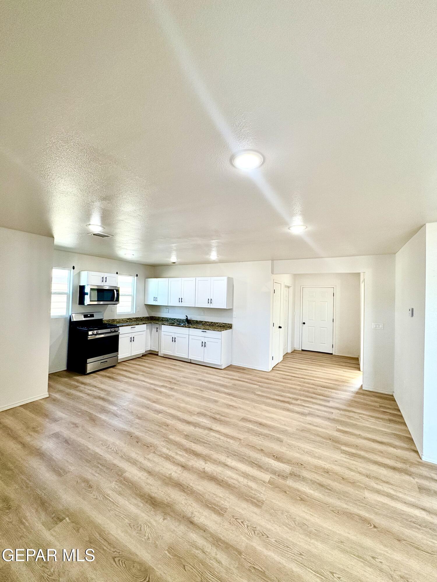 11420 Doris Road Socorro, TX 79927 - Photo 8 of 27 a view of a kitchen with a sink and a stove top oven