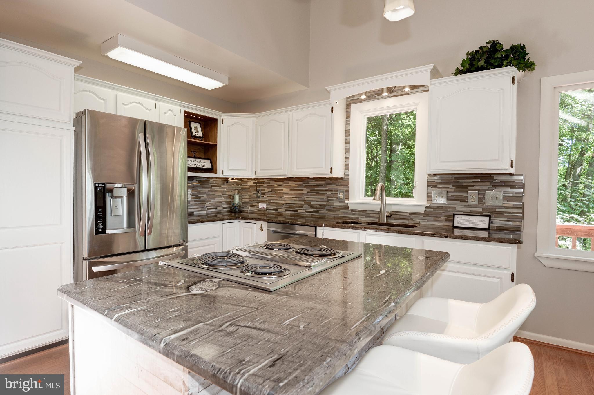 1619 Summit Drive Haymarket, VA 20169 - Photo 9 of 62 a kitchen with stainless steel appliances granite countertop a sink stove and refrigerator