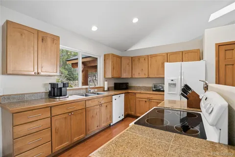 a kitchen with a sink stove and cabinets