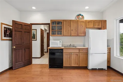 a kitchen with stainless steel appliances granite countertop a refrigerator a stove and a sink