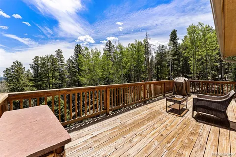a view of balcony with wooden floor and outdoor seating