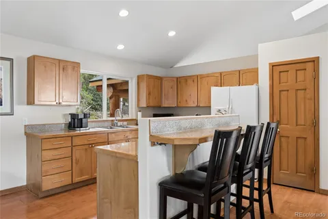 a kitchen with a table chairs refrigerator and microwave