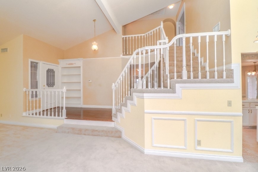 1429 Hawkwood Road Henderson, NV 89014 - Photo 8 of 53 Vaulted ceilings and a sweeping staircase welcome guests into this multi-level entry foyer.