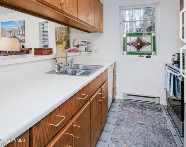 a kitchen with stainless steel appliances granite countertop a sink and cabinets