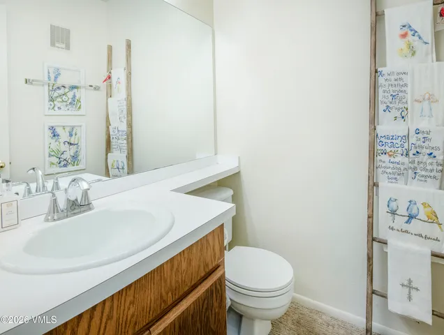 a bathroom with a sink toilet and vanity