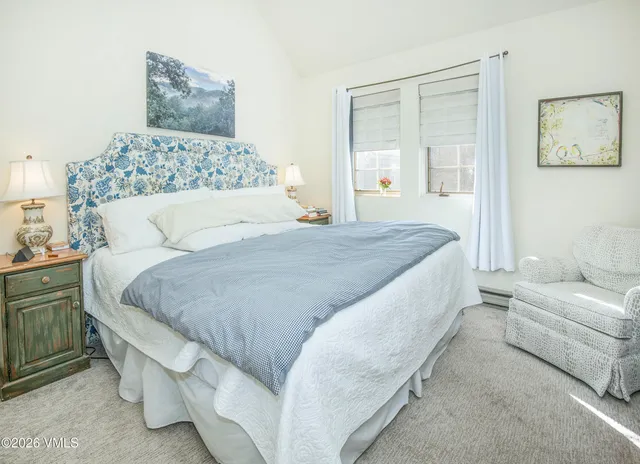 a bedroom with a large bed and a couch