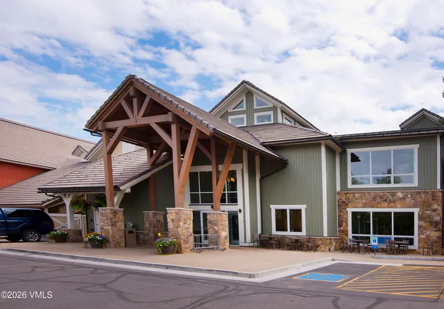 a view of a house with backyard and sitting area