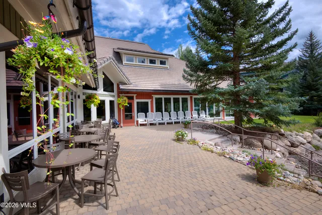 an aerial view of a house with garden space and mountain view in back