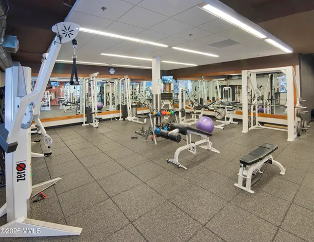 a room with gym equipment and white walls