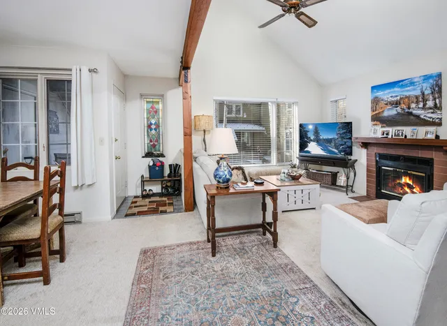 a living room with furniture a fireplace and a flat screen tv