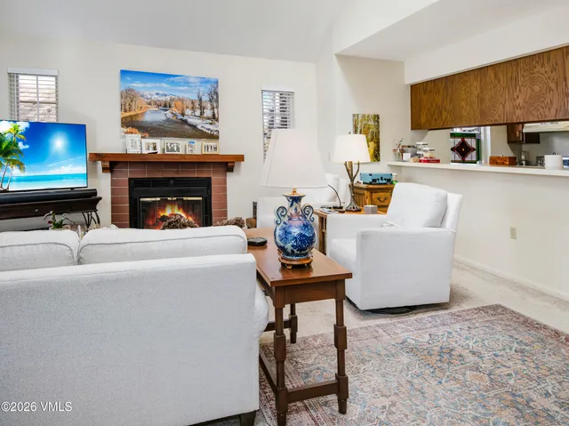 a living room with furniture a fireplace and a flat screen tv