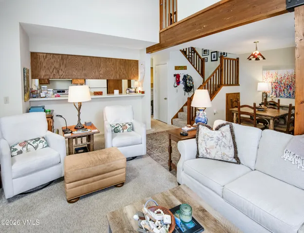a living room with furniture and kitchen view