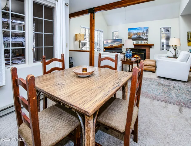 a dining room with furniture and wooden floor