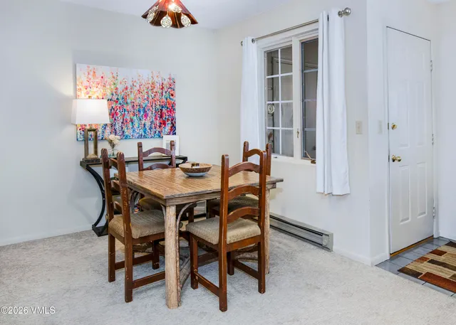 a dining room with furniture and a window