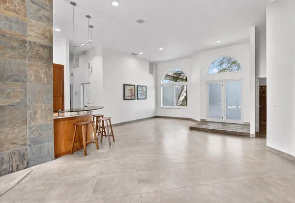 a view of kitchen with furniture and refrigerator