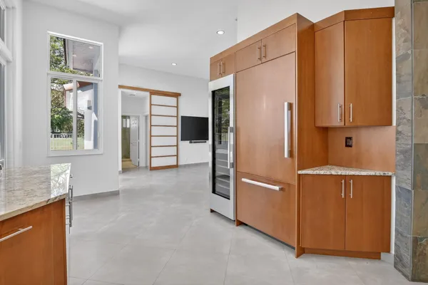 a kitchen with stainless steel appliances granite countertop a refrigerator and a sink